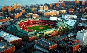 Aerial view of Fenway Park baseball stadium and surrounding brick buildings in Boston.