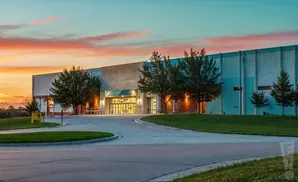 Modern building at sunset with a colorful sky.