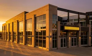 Joe's Live entertainment venue exterior at sunset with dramatic lighting and long shadows.