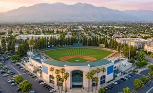 Aerial view of a baseball stadium with mountains in the background.