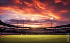A baseball stadium at sunset with a fiery orange and purple sky.