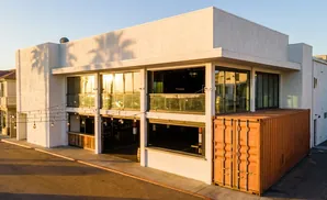 Modern building with large windows and an orange shipping container.