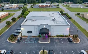 Aerial view of Stardome, a white building with a star logo, in a parking lot.