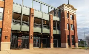 Brick stadium exterior with multiple levels of seating and dark metal railings.
