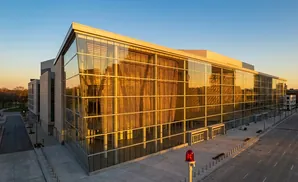 Modern glass building with golden reflections of sunset.