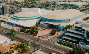 Aerial view of a large convention center with a domed building and an arena.