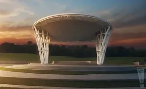 An outdoor amphitheater with a modern white canopy and tiered seating.