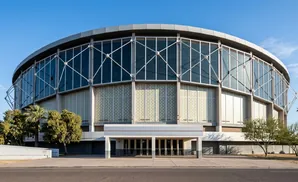 A circular, glass-fronted arena with a modern facade and a covered entrance.