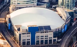 Aerial view of the Rogers Centre stadium with its domed roof and surrounding urban landscape.