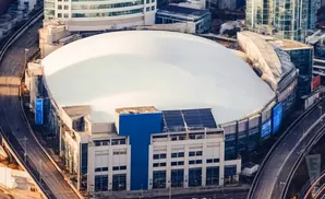 Aerial view of a large domed stadium with surrounding elevated roads and buildings.