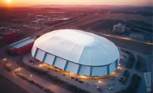 Aerial view of a domed stadium at sunset.