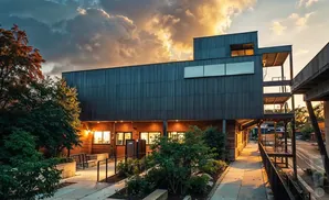 Modern building with wooden accents and balconies at sunset.