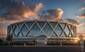 A modern, diamond-patterned arena at sunset, with dramatic clouds.