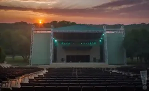 An outdoor amphitheater stage at sunset.