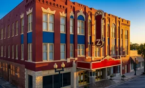Maroon and blue historic theater with a marquee reading 