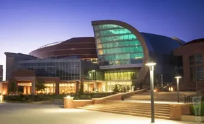 Modern building with curved glass and brick exterior at dusk.