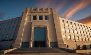 Art Deco building with wide stairs leading to a grand entrance under a dramatic sunset sky.