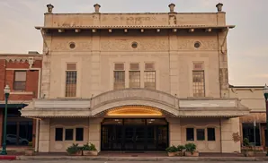 The Crition Theater, a historic building with intricate architectural details, stands proudly with a marquee and grand entrance.