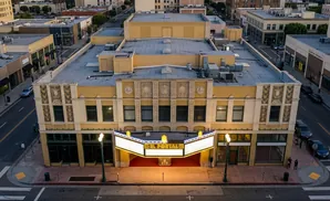 An aerial view of the historic El Portal theater with its marquee lit up.