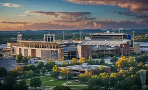 An aerial view of Neyland Stadium and surrounding grounds in Knoxville, Tennessee at sunset.