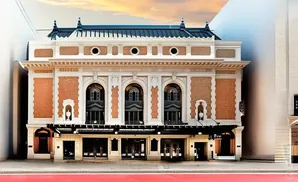 Elegant theater with ornate facade, brick accents, and arched windows.