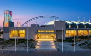 Ocean City Convention Center at dusk with a Ferris wheel and colorful tower.