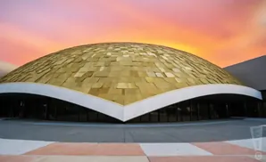 A golden dome building at sunset.