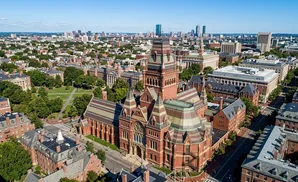 Aerial view of Harvard University's Widener Library and surrounding historic buildings and greenery.