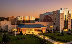 Modern casino with colorful glass accents at sunset.
