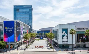 LA Live complex with JW Marriott hotel, Microsoft Square, Grammy Museum, and Peacock Theater under a cloudy sky.