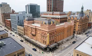 Aerial view of a historic theater building and surrounding city blocks.