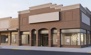 A storefront with a large blank sign and display windows showing art.