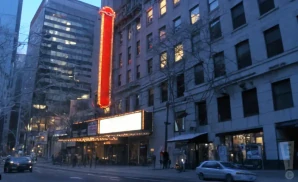 an exterior promotional venue picture of 5th avenue theatre with a dawn sky