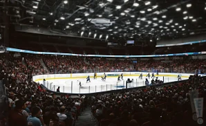 interior picture of acrisure arena, there is a hockey match going on