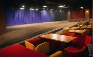 a realistic promo venue photograph of the baltimore comedy factory canton at night. 