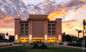 an exterior promotional venue picture of barbara b mann performing arts hall with a sunset sky