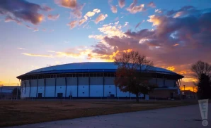 an exterior promotional venue picture of brick breeden fieldhouse with a sunset sky