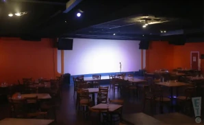 a realistic promo venue photograph of the chuckles comedy house tn at night.