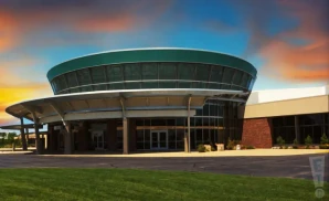 an exterior promotional venue picture of dow arena at dow event center with a sunset sky