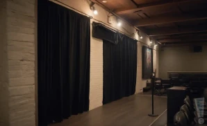 a realistic promo venue photograph of the dr grins comedy club at the bob at night.