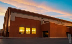 an exterior promotional venue picture of el paso county coliseum with a sunset sky