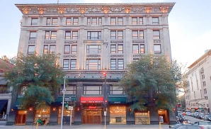 an exterior promotional venue picture of emerson colonial theatre with a sunset sky