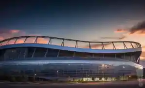 a picture of the empower field at mile high from across the street during the sunset 