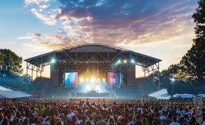 an exterior promotional venue picture of forest hills stadium with a sunset sky