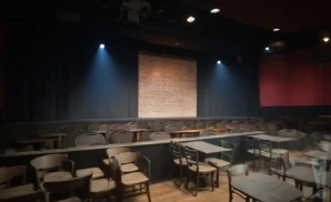 a realistic promo venue photograph of the funny bone comedy club syracuse at night. 