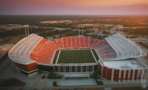 a realistic drone promo venue photograph of gerald j ford stadium at sunset. 