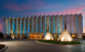 a promotional exterior photograph capturing the full front view of the grey eagle resort & casino in calgary at dusk.