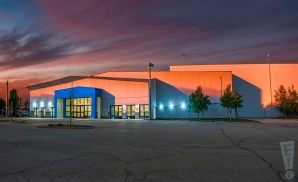 a promotional exterior photograph of hartman arena in park city, kansas, captured at golden hour.