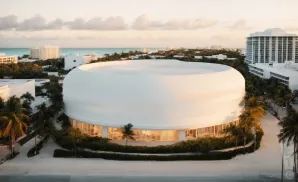 an exterior picture of the kaseya center rom across the street during sunset