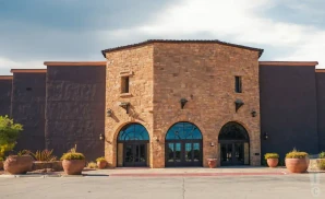 exterior promotional venue picture of la hacienda event center with a cloudy sk